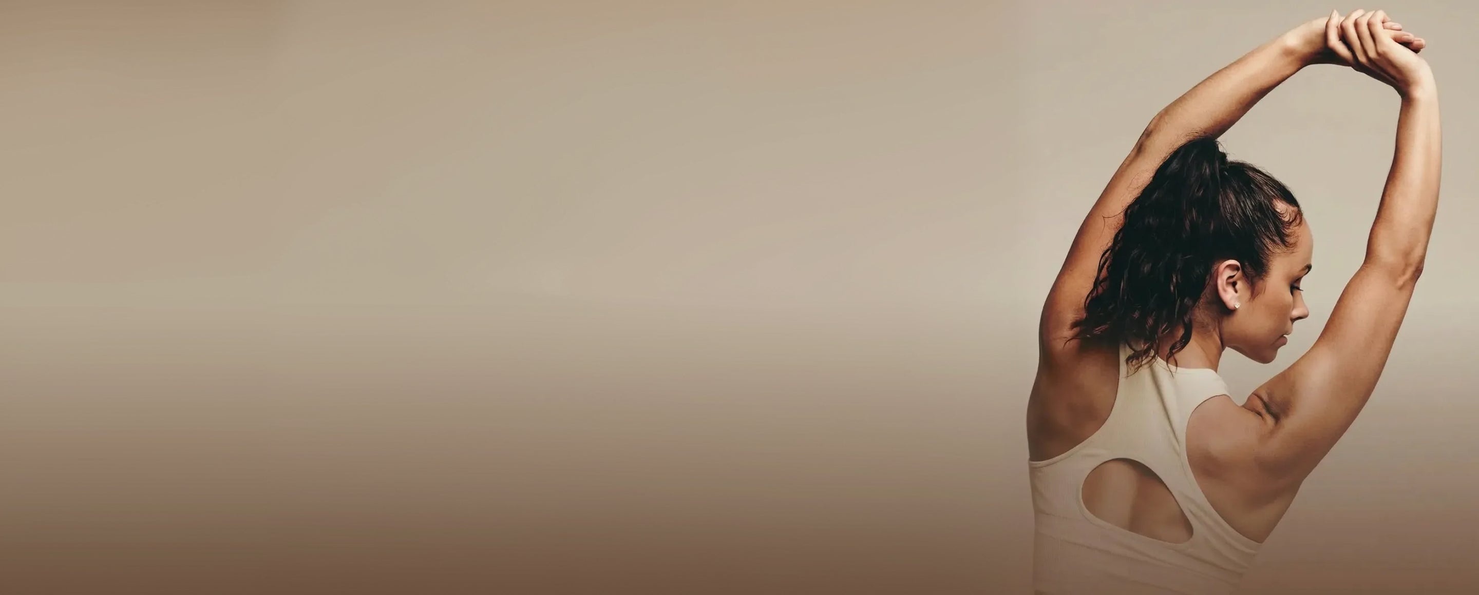 Woman stretching with a beige background