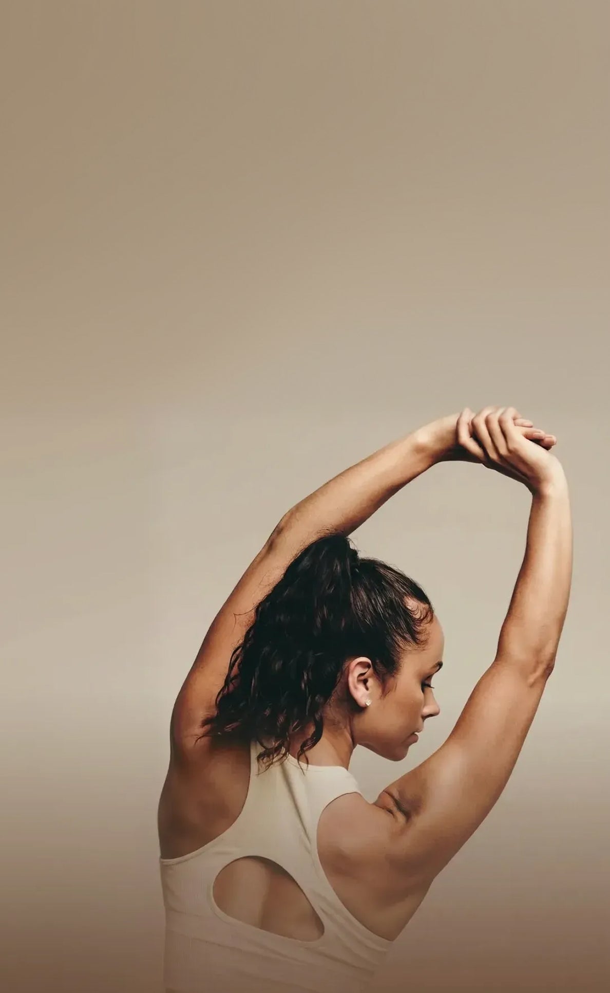 Woman stretching with a neutral background