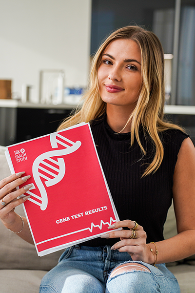 woman holding 10X Health gene test results folder